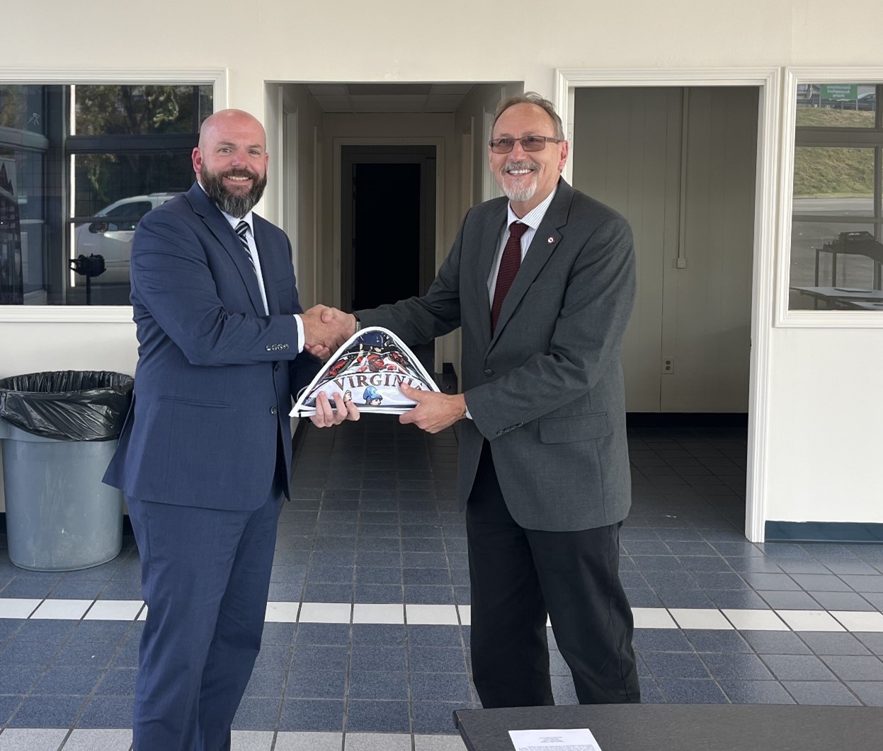 Virginia Delegate Jed Arnold, R -  46th District (Grayson, Pulaski (part), Smyth, and Wythe Counties), recently presented Wytheville Community College (WCC) President Dr. Dean Sprinkle with the state flag of Virginia to be displayed at WCC’s newest workforce education and training center, WCC WEST (Workforce, Education, & Skills Training). 

“WCC extends a heartfelt thank you to Delegate Arnold for the generous gift of the state flag to commemorate the opening of WCC WEST. Your support plays a vital role in the success of these workforce development students,” said Dr. Sprinkle. “We will display the flag proudly inside the new facility.” 

WCC celebrated the opening of WCC WEST on October 3, 2024, with a ribbon-cutting ceremony co-hosted by the Smyth County Chamber of Commerce. 
The facility in Marion, VA, enhances WCC’s capacity to provide much-needed workforce training in high-demand skilled trades in Smyth County and the western portion of the college’s service area.

WCC WEST currently offers an automotive training program and a welding program and plans to expand into additional skilled trades. The center is designed to provide hands-on training that meets the growing workforce demands of the region. 
Pictured: (L-R) Delegate Jed Arnold and Dr. Dean Sprinkle